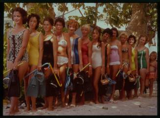 Shot of women standing in line in swimwear holding dive gear