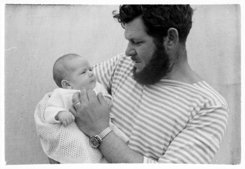 Black and white medium shot of person holding baby in their arms