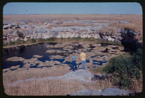 Two people looking at a body of water