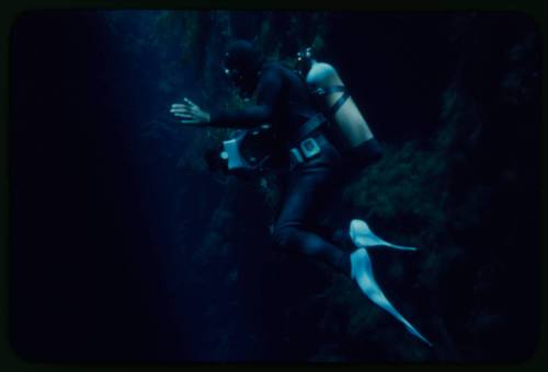 Diver underwater with right hand open