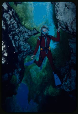 Valerie Taylor underwater in a crevice