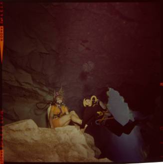 Two divers underwater inside a cave