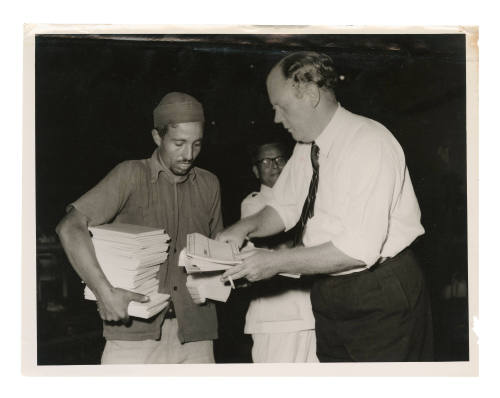 Officials with documents in association with arrival at Aden of survivors from the sinking of the MV SKAUBRYN