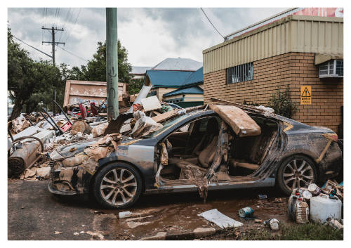 Car amongst pile of flooded debris