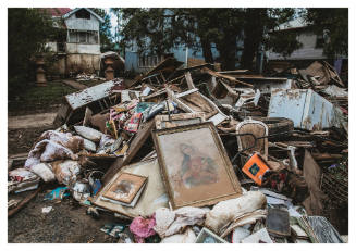 Framed image of Virgin Mary on top of household debris