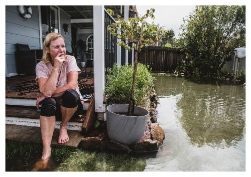 Person looking at flooded garden