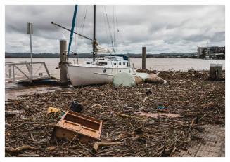 Washed up yacht amongst debris