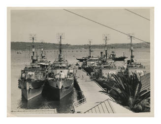 Six Bathurst-class corvettes of the Royal Australian Navy at Watsons Bay, Sydney Harbour, with the pilot vessel CAPTAIN COOK III passing behind