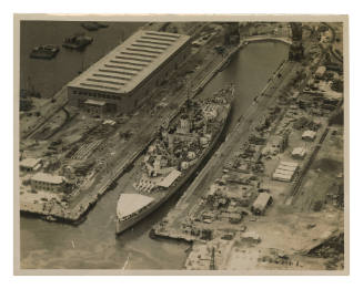 Aerial view of King George V class battleship at Garden Island Naval Dockyard, Sydney Harbour