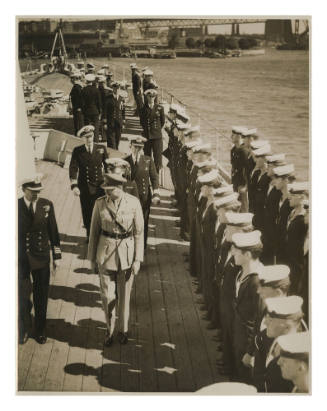 Naval officers on deck, under inspection by an Army officer