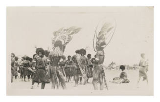 Group of people with two in headdresses