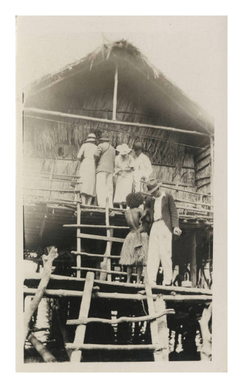 People at entrance of stilt house