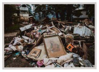 Framed image of Virgin Mary on top of household debris