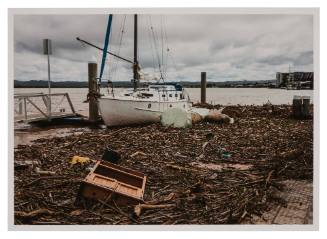 Washed up yacht amongst debris