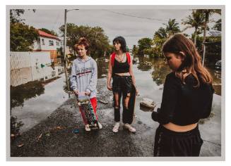 Three girls on a flooded road