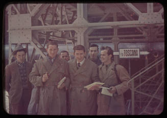 Six men next to a sign reading TOSCANA