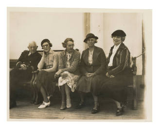 Five people seated on wooden benches