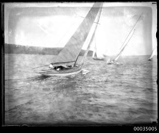 Sailing regatta in harbour with four boats racing