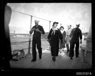 United States Navy sailors with female visitors on board USS ASTORIA