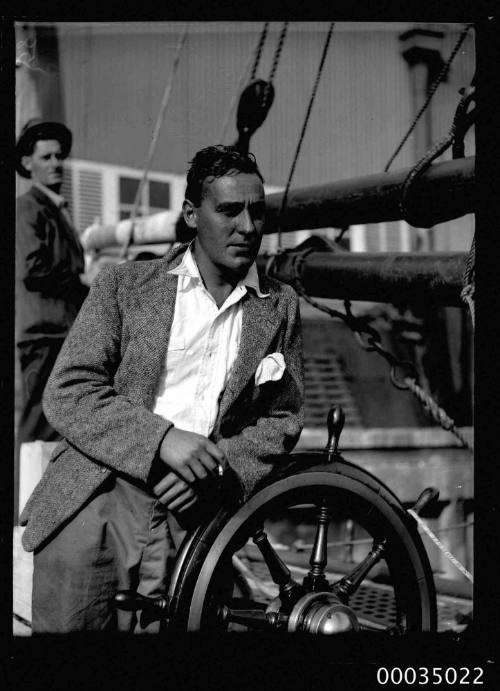 Man at the wheel of the sailing ketch CORWA