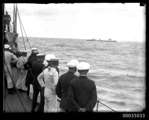 Royal Australian Navy officers and sailors watching the sinking of HMAS TORRENS I