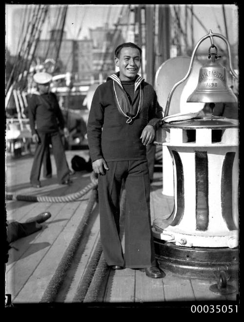 Chilean sailor alongside the ships bell on the deck of GENERAL BAQUEDANO during a visit to Sydney