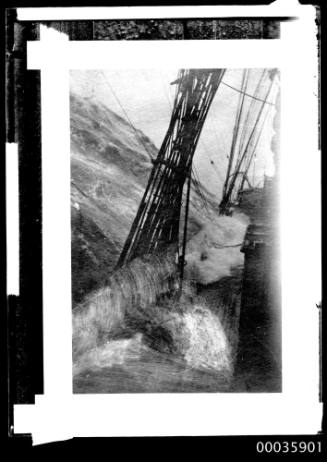 Glass plate negative of water spilling on to the waist of a tall ship