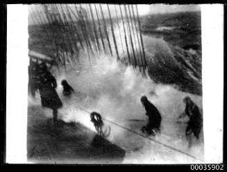 Glass plate negative of water spilling on to the waist of a tall ship