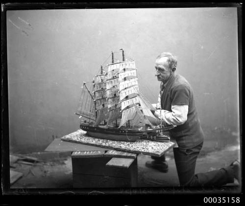 Man with a model of a fully rigged ship