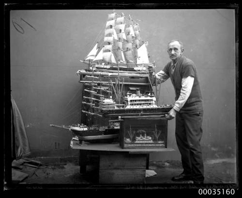 Man with various ship's models