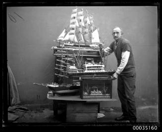 Man with various ship's models