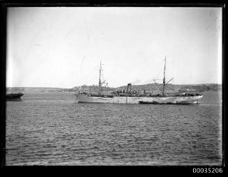 Cargo ship at anchor in harbour 