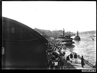 Royal Navy sailors and officers disembark from a ferry at Woolloomooloo Bay in Sydney