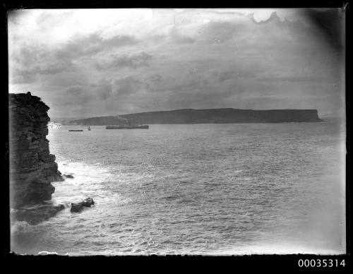 Steamship and tug leaving Sydney Harbour at North Head