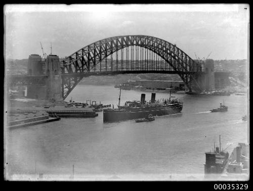 Cargo ship and tugs