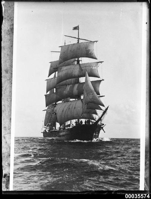 Three masted barque underway with sails set.