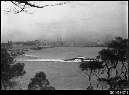 View of Sydney Cove with ferry punt and tugboats.