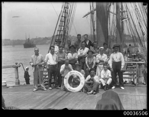 Group of men posing on the wharf in front of MOUNT STEWART