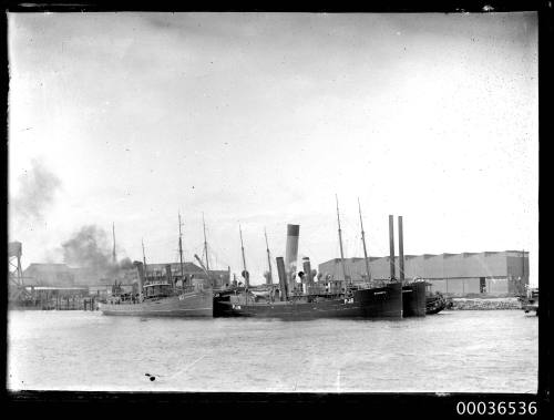 Steam vessels including B1, PJ4, PJ6 (DISSIU) moored near a wharf