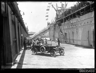 Partial view of a passenger ship docked at a wharf possibly in Sydney