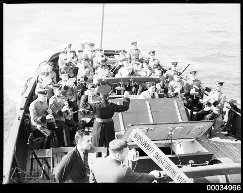 ABC Military Band playing with ABC commentator on a vessel
