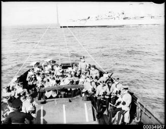 ABC Military Band playing with ABC commentator on a vessel