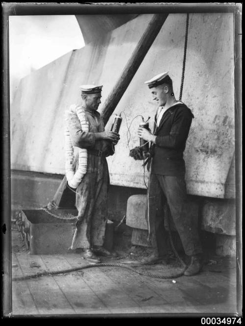 Sailors with demolition charges on HMAS AUSTRALIA I