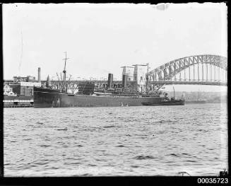 Unidentified passenger vessel with tug departing Sydney Cove.