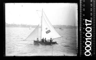 16-foot skiff featuring an emblem on the mainsail of a light cross over a dark square with the number '47', Sydney Harbour