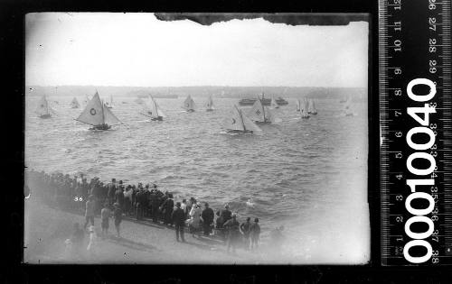 Spectators gather to watch the start of an 18-footer race off Clark Island, Sydney Harbour