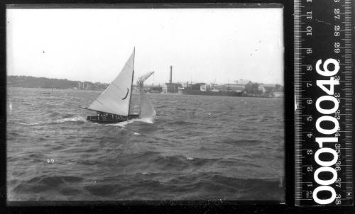 16-foot skiff with a crescent on the mainsail sailing near Cockatoo Island, Sydney Harbour