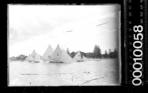 Damaged image of 18-footers and 14-footers sailing close to shore, Botany Bay.