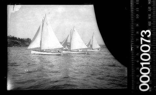 Three amateur class yachts sailing on Sydney harbour