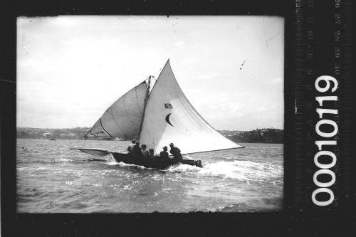 16-foot skiff with the number '69' and a cresent emblem displayed on the mainsail, Sydney Harbour